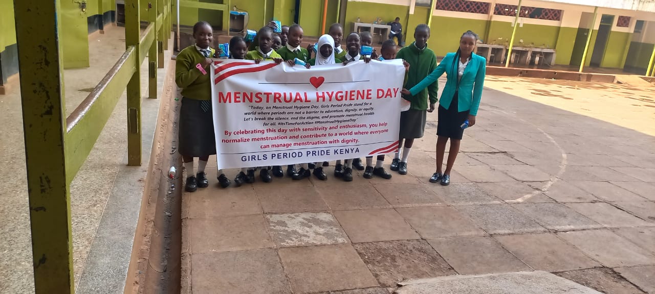 Students celebrating Menstrual Hygiene Day with Period Pride Kenya banner